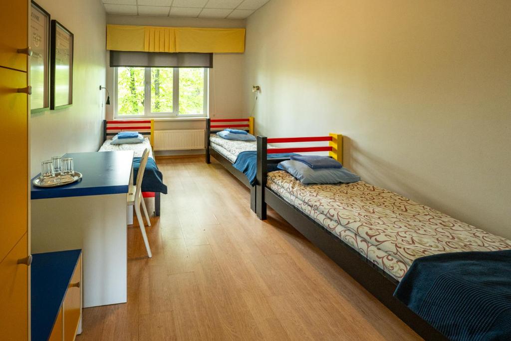 Postel nebo postele na pokoji v ubytování Tamme staadioni hostel