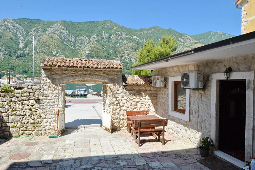an entrance to a stone building with a wooden bench at Kuzman Apartments in Kotor