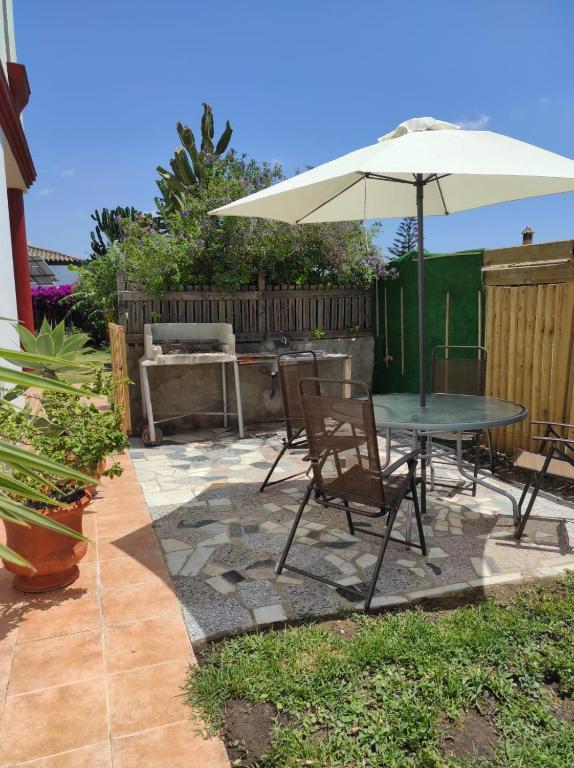 a patio with a table and an umbrella at La Buena Vida, el Palmar in El Palmar