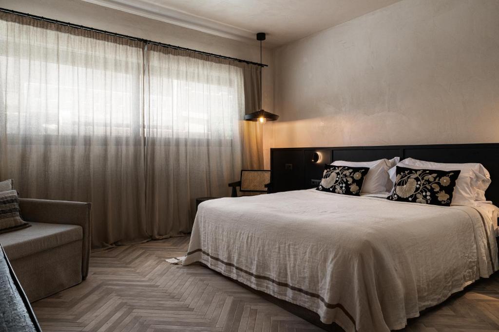 a bedroom with a large bed and a window at Abella Suites Embonas in Émbonas