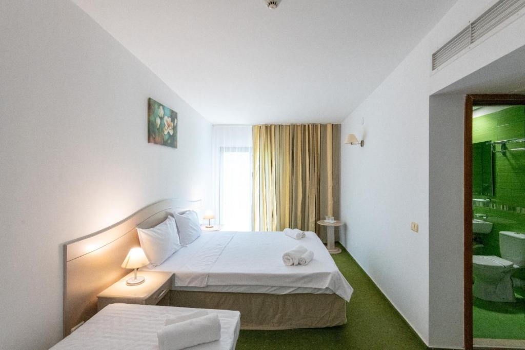 Postel nebo postele na pokoji v ubytování Complex Bran Brad Bega