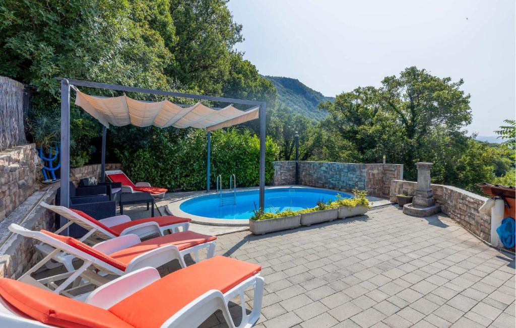 a patio with chairs and a swimming pool at Beautiful Apartment In Bribir With Wifi in Bribir