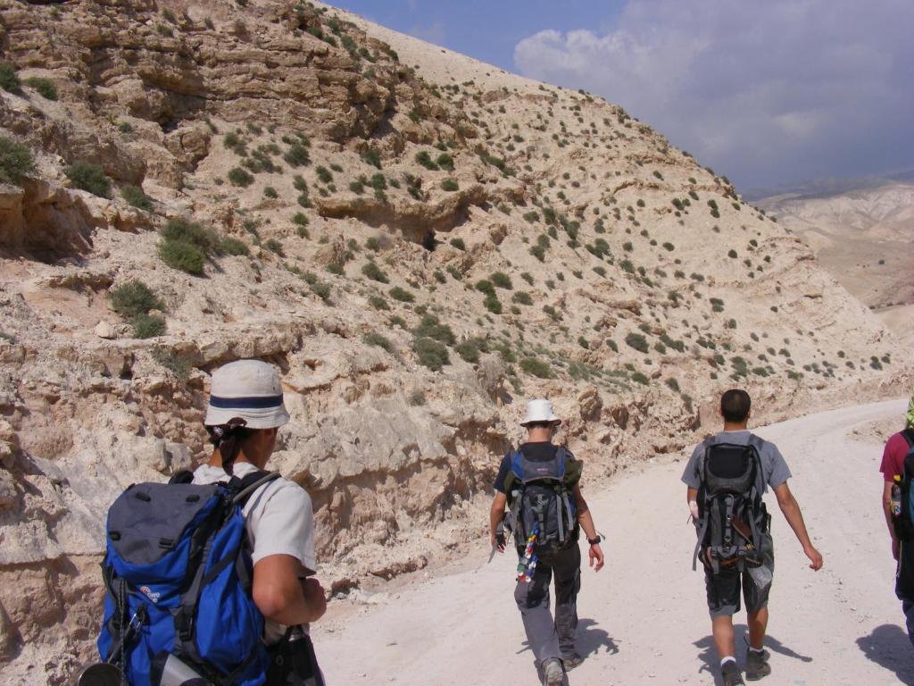 a group of people walking up a mountain at Nof Canaan in Kfar Adumim