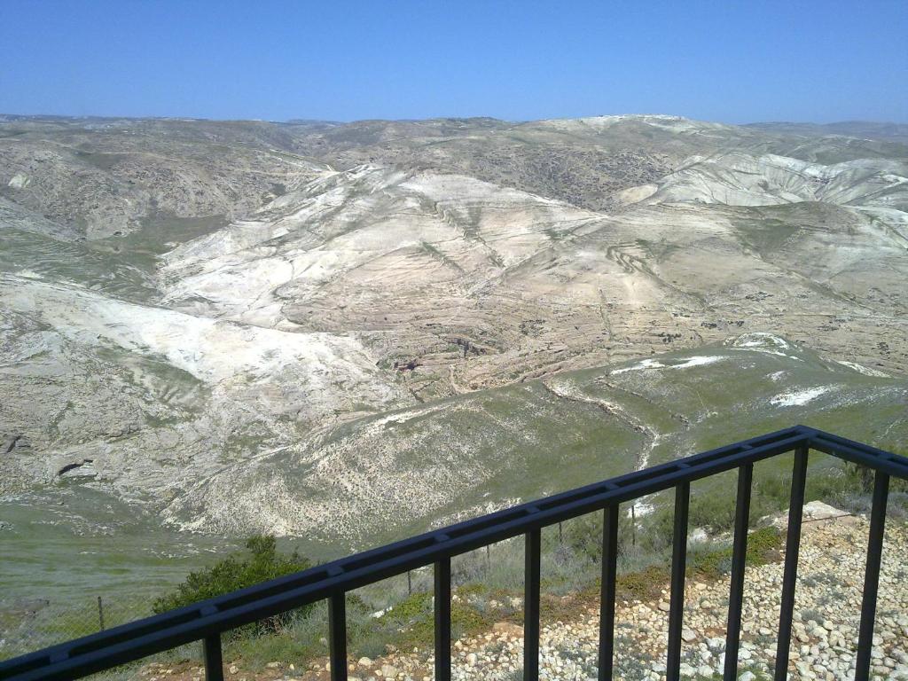 a view of a snowy mountain from a balcony at Nof Canaan in Kfar Adumim