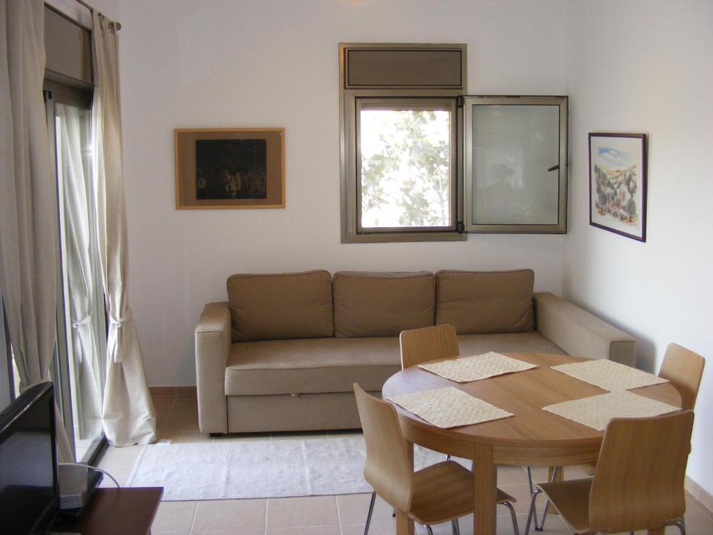 a living room with a couch and a table at Nof Canaan in Kfar Adumim