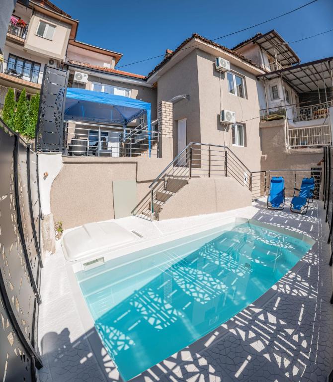 a swimming pool in front of a house at Villa DukiBalo in Ohrid