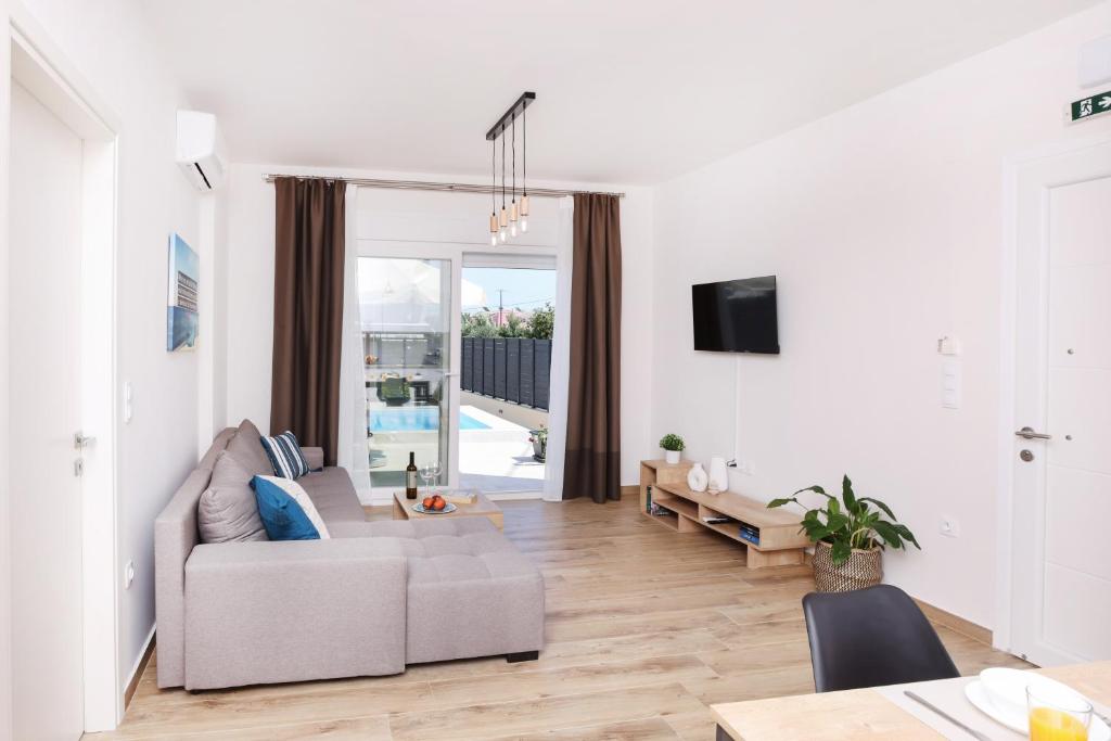 a living room with a couch and a table at Poet Villa in Agios Georgios