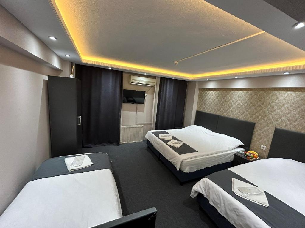 Postel nebo postele na pokoji v ubytování Grand Sezgin Hotel