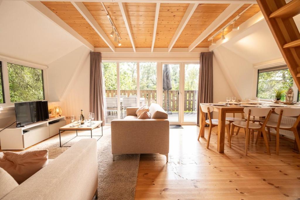 a living room with a table and a dining room at Hidden jewel in Durbuy's forest in Durbuy