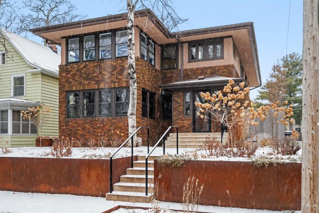 a brick house with snow on the ground at Colfax Commons in Minneapolis