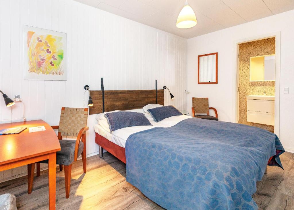 Postel nebo postele na pokoji v ubytování Hotel Aarslev Kro