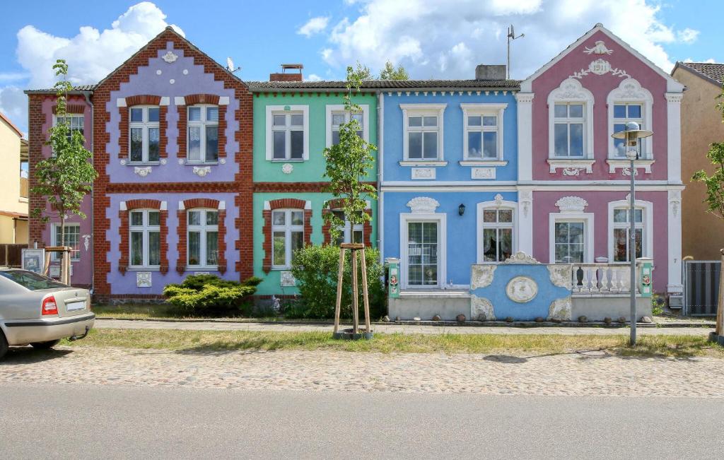 a row of colorful houses with a car parked in front at Ferienwohnung Fürstenberg in Pian