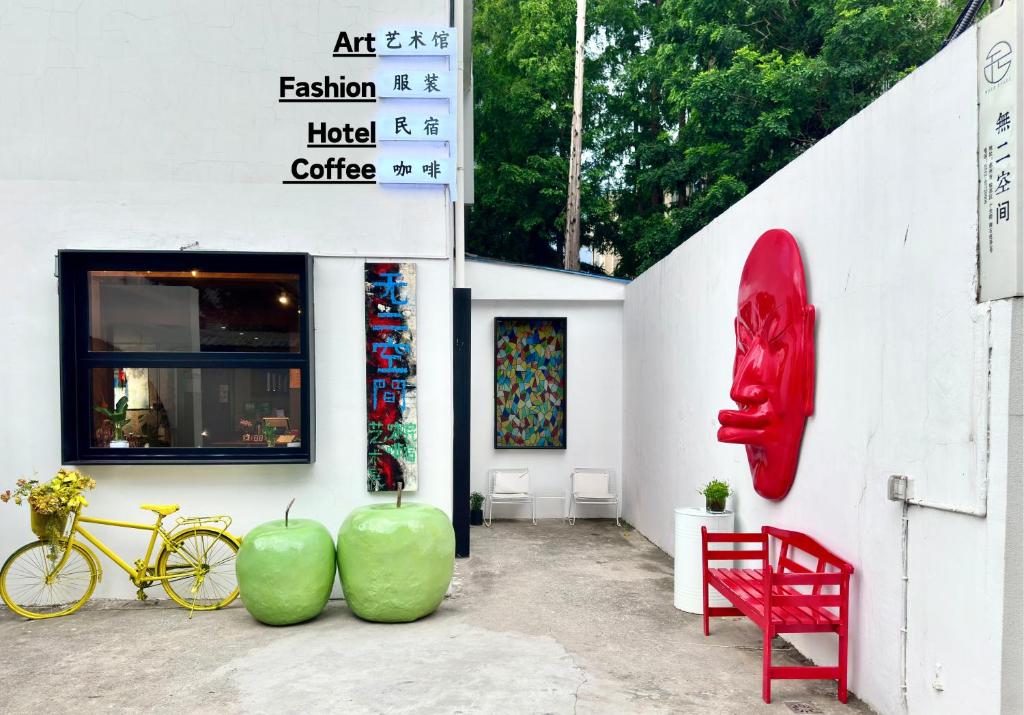 a building with a red bench and a red chair at Suzhou Unique Space Design Art Hotel in Suzhou