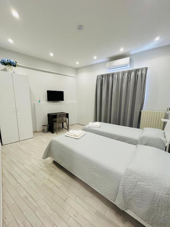 a hotel room with two beds and a television at B&b Al Centro Nicosia in Nicosia