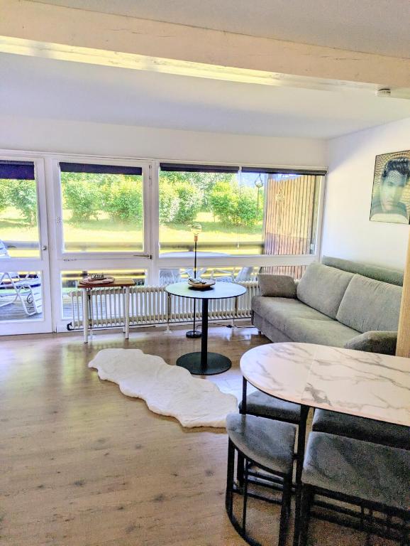 a living room with a couch and a table at Gemütliche Ferienwohnung in den Bergen in Siegsdorf