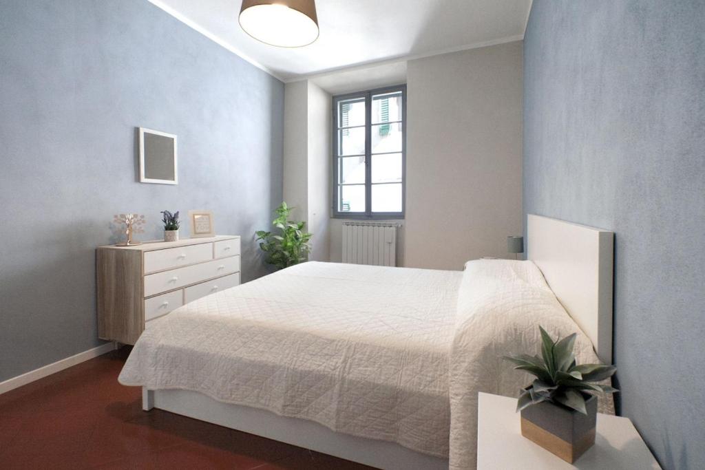 Ένα ή περισσότερα κρεβάτια σε δωμάτιο στο I Quattro Cantoni Apartment