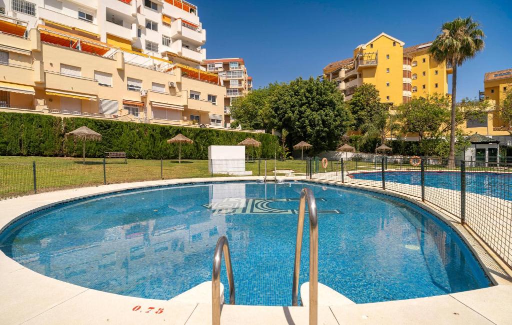 a large swimming pool in front of some buildings at Awesome Apartment In Benalmadena in Benalmádena