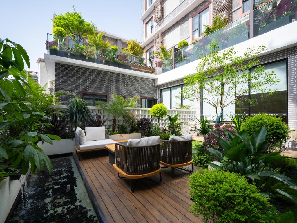 a patio with furniture and plants on a building at Starway Hotel Guilin Two Rivers and Four Lakes Scenic Area in Guilin