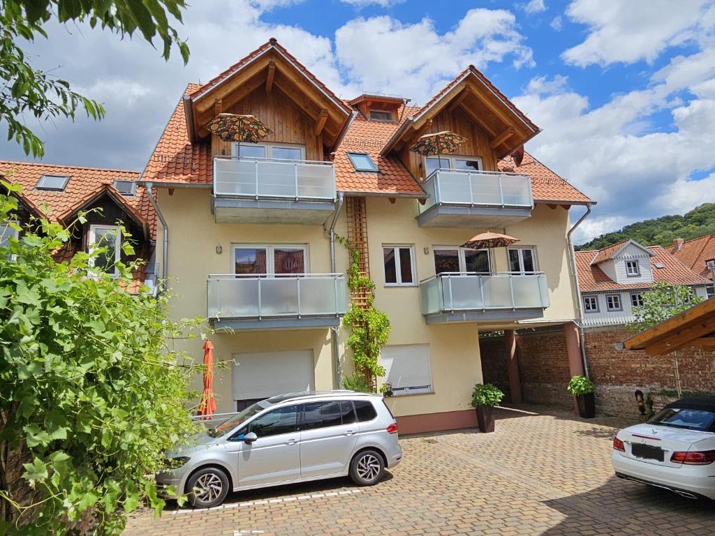 a house with a car parked in front of it at Ferienwohnungen Burgfried in Wernigerode