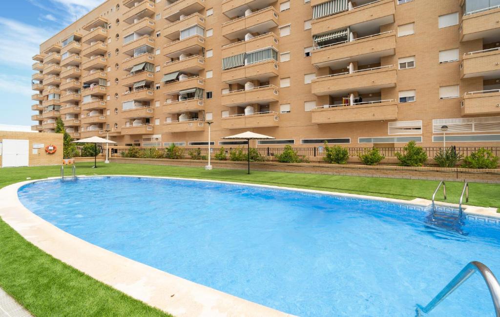 a large swimming pool in front of a building at Amazing Apartment In Oropesa Del Mar in Oropesa del Mar