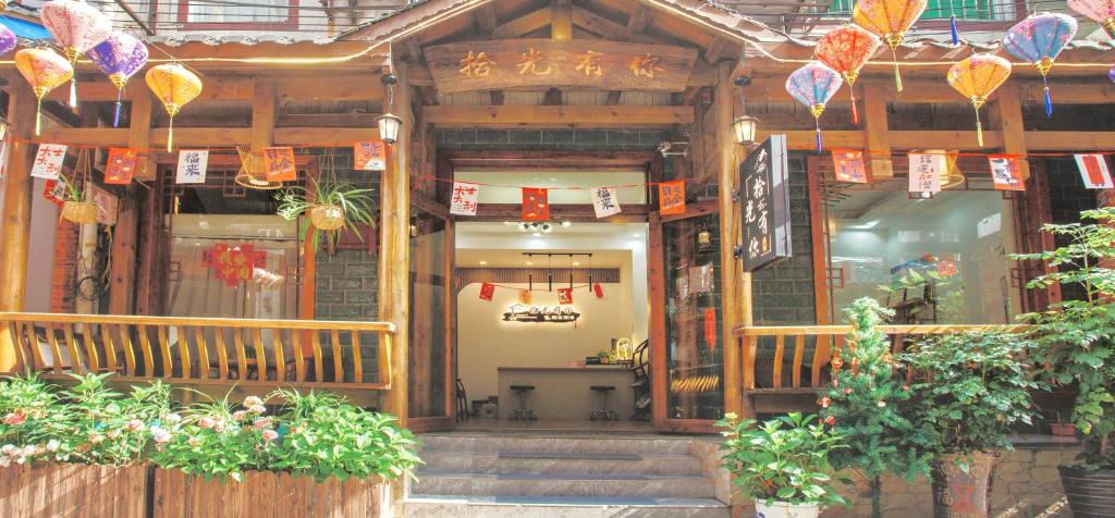 an entrance to a building with signs and plants at 拾光有你民宿-Inn-Tianmen mountain-Book ticket service in Zhangjiajie
