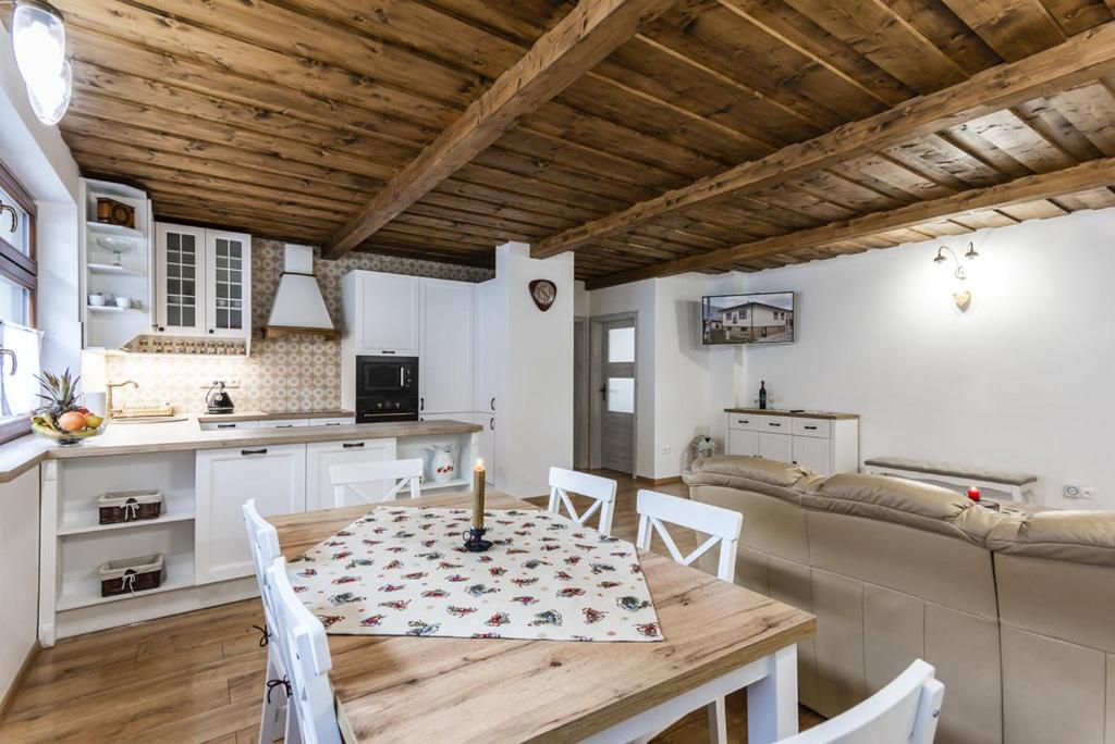 a kitchen and dining room with a table and chairs at Chalupa u sv Martina in Tvrdošín
