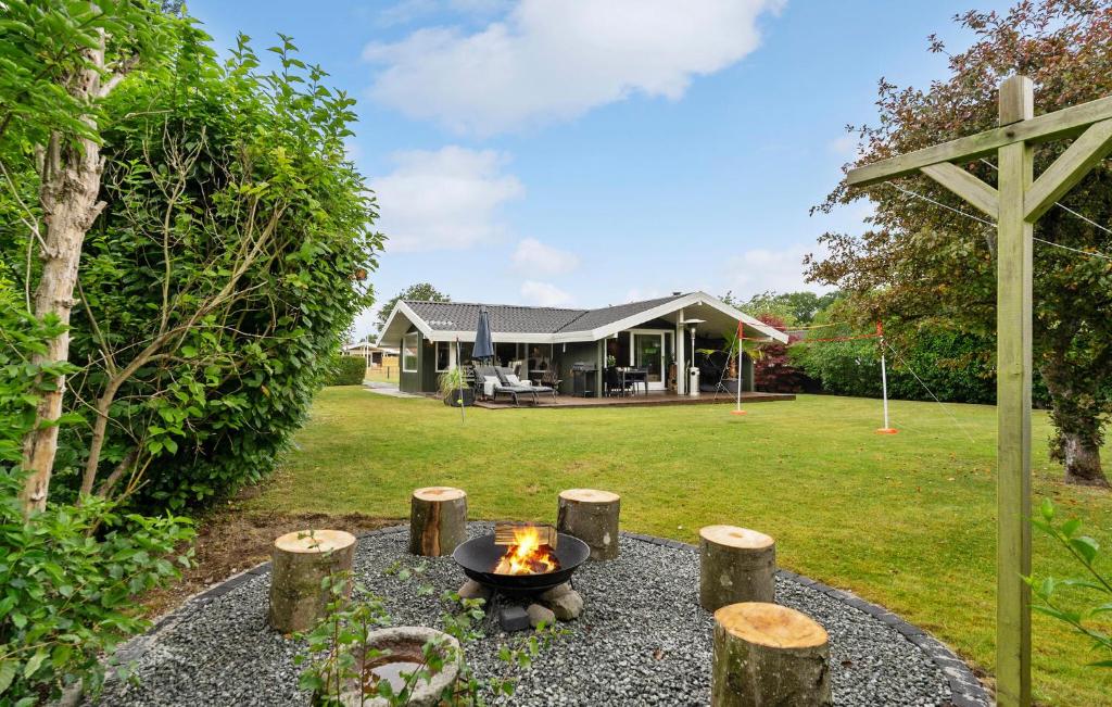 a fire pit in the backyard of a house at 4 Bedroom Awesome Home In Otterup in Otterup