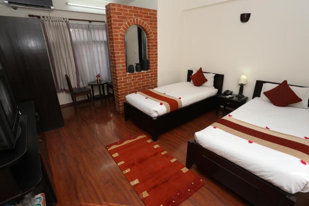 Postel nebo postele na pokoji v ubytování Thamel Eco Resort