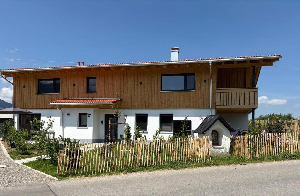 a house with a wooden fence in front of it at Alm Annerl - Neue Ferienwohnungen in Obermaiselstein in Obermaiselstein