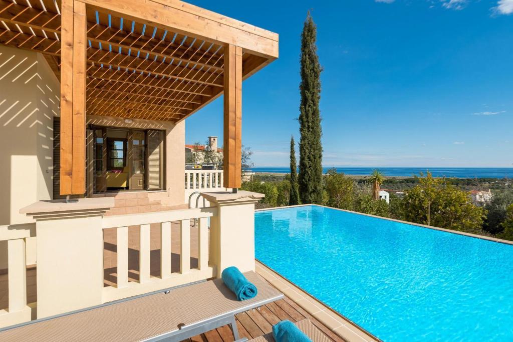 a villa with a swimming pool and a gazebo at Villa Athina in Kalathos