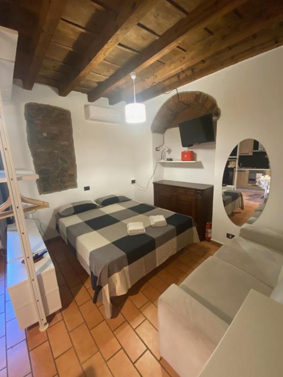 a large bedroom with a bed and a couch at Il Fiore nascosto in Bergamo