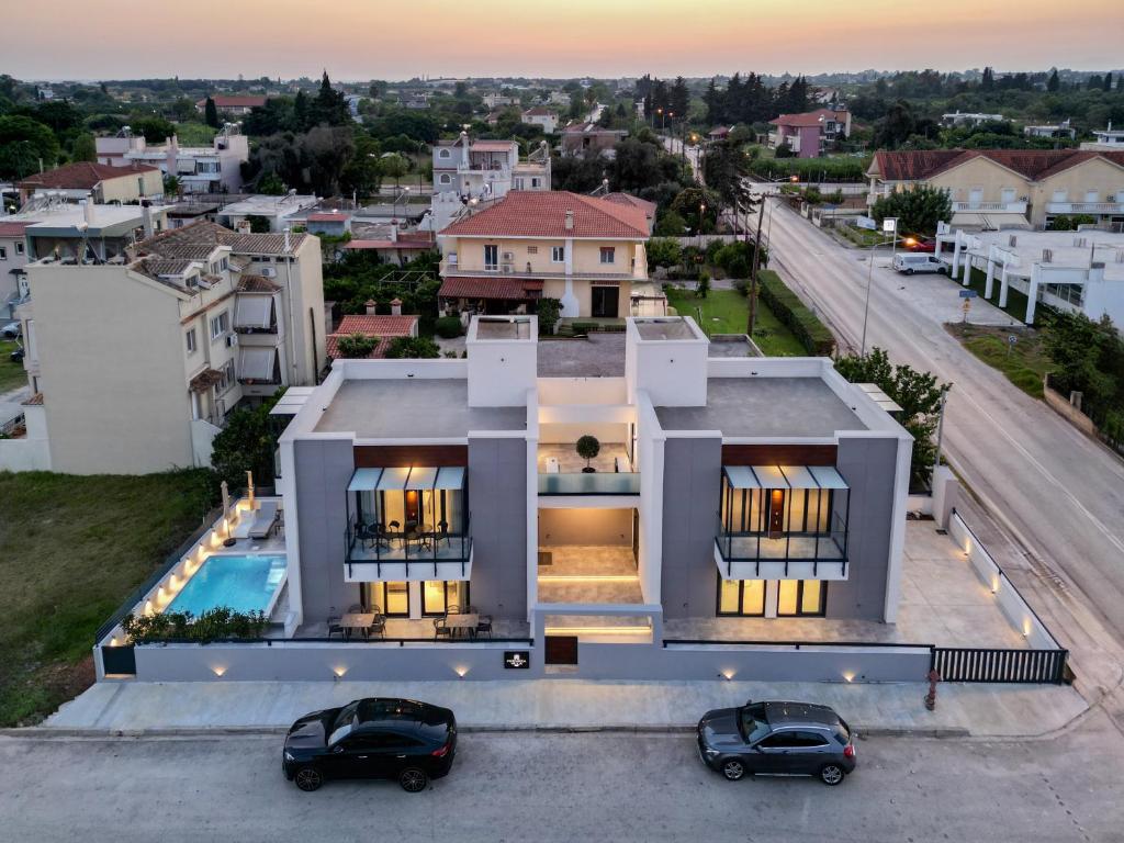 an aerial view of a house with two cars parked in front at PREVEZA VILLA center in Preveza