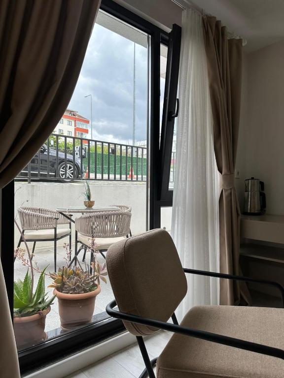 a room with a balcony with chairs and a window at THE DECK OTEL in Trabzon