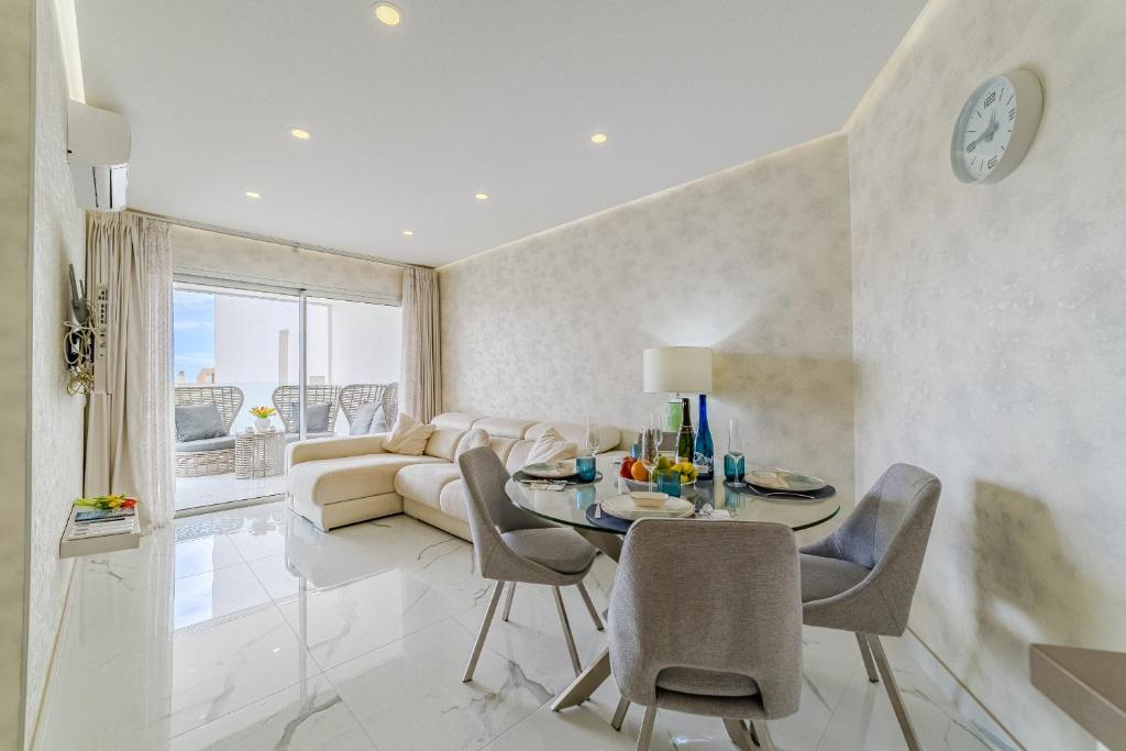 a living room with a table and a couch at Poolside Escape - airco & heated pool in Adeje