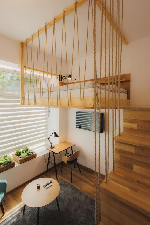 a room with a loft bed and a desk at Bambi Boutique Rooms - Loftové izby 300 m od centra Banskej Bystrice, Self check-in in Banská Bystrica