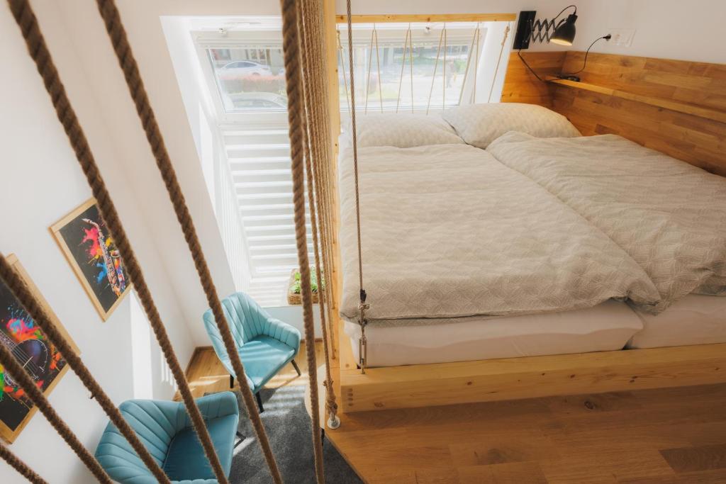 a bedroom with a bed in a mirror at Bambi Boutique Rooms - Loftové izby 300 m od centra Banskej Bystrice, Self check-in in Banská Bystrica
