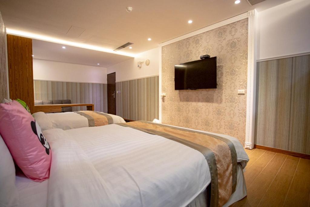 Postel nebo postele na pokoji v ubytování Garden Spring Hotel