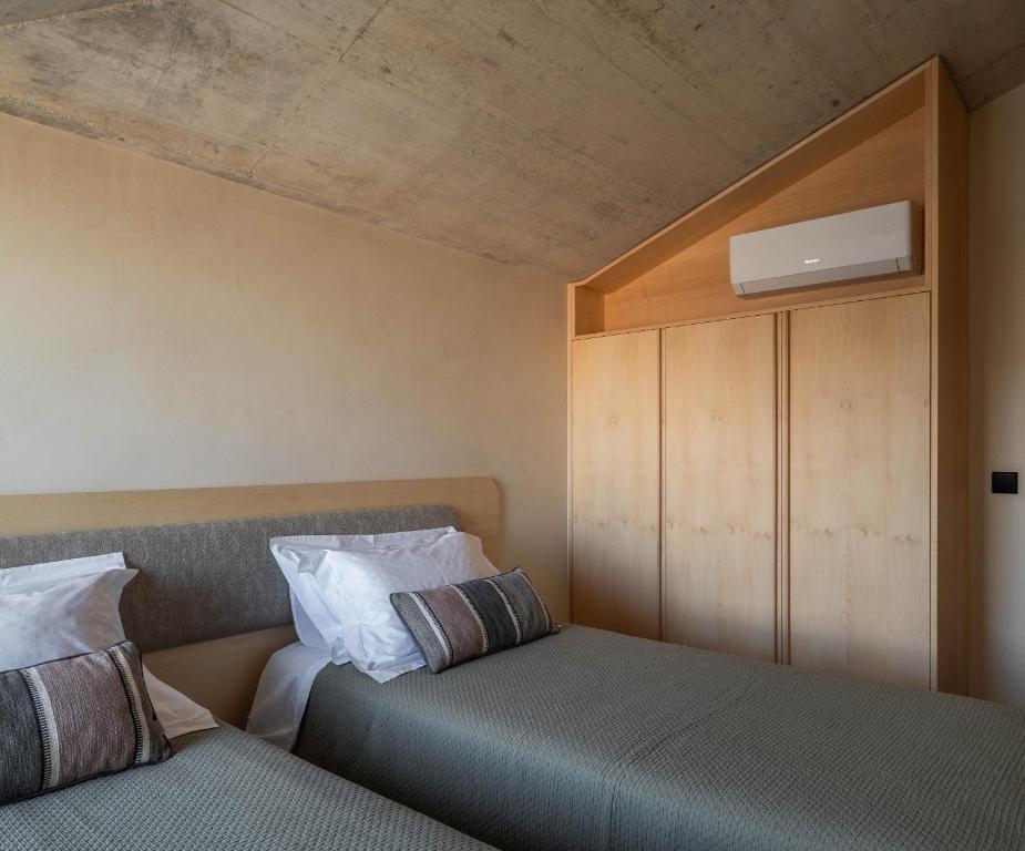 a bedroom with two beds and a ceiling at Coelho 145 in Porto