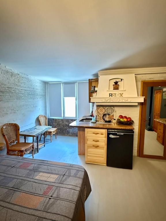 a kitchen with a stove and a table in a room at Art Lux Studio 1 in Burgas City