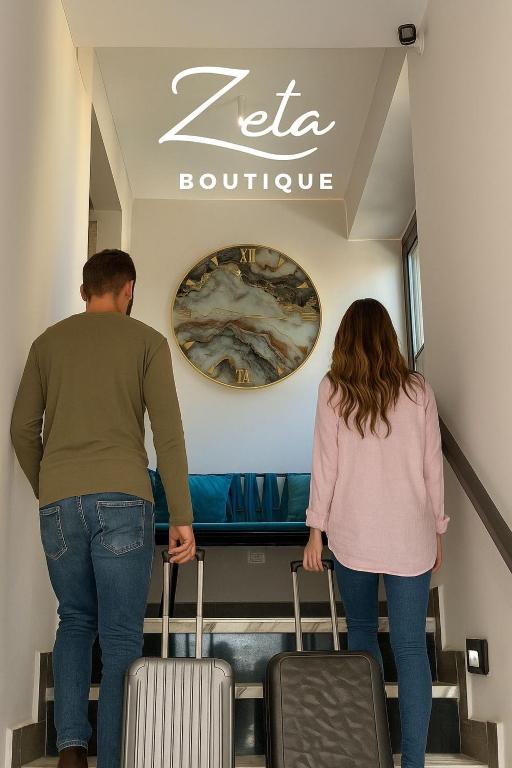 a man and a woman walking up an escalator with luggage at Zeta Boutique in Caserta