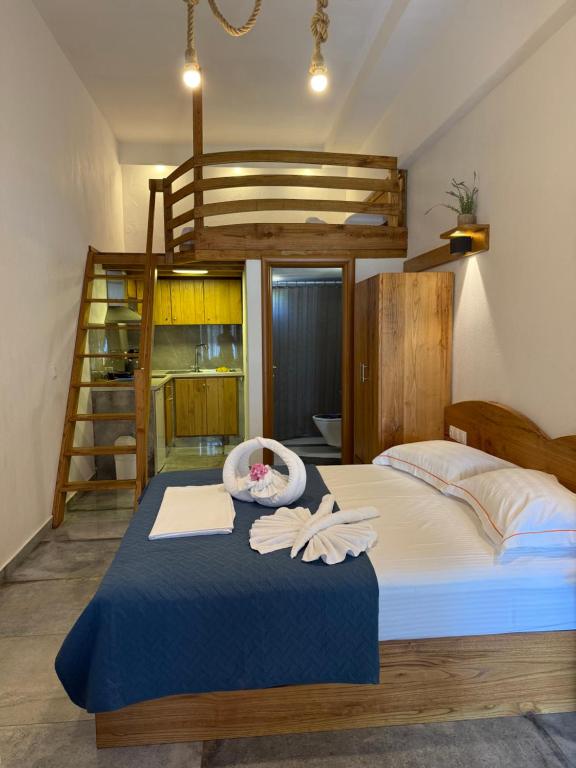 a bedroom with a bunk bed with a ladder at Pinelopi’s House in Porto Koufo