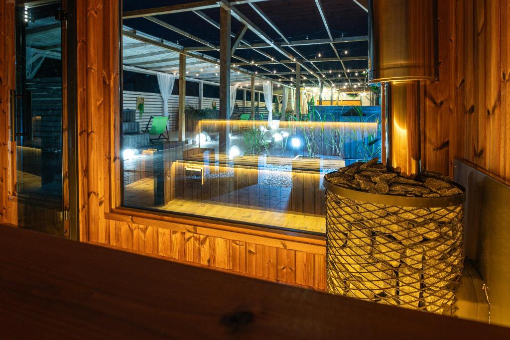 a view of a pool from a window at night at Old Tree Home & Restaurant in Oświęcim