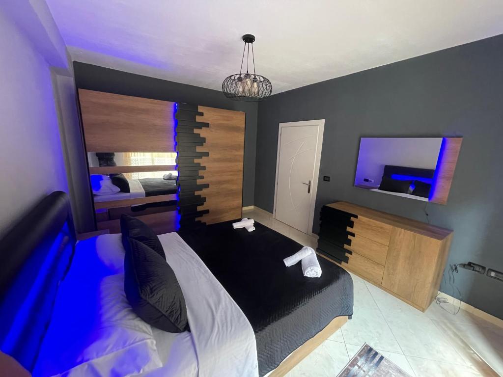 a bedroom with a large bed and a television at Luxury apartment 2 in Pogradec