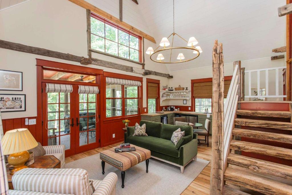 a living room with a green couch and a table at The Cardinal at Buckhorn Hollow in McEwen