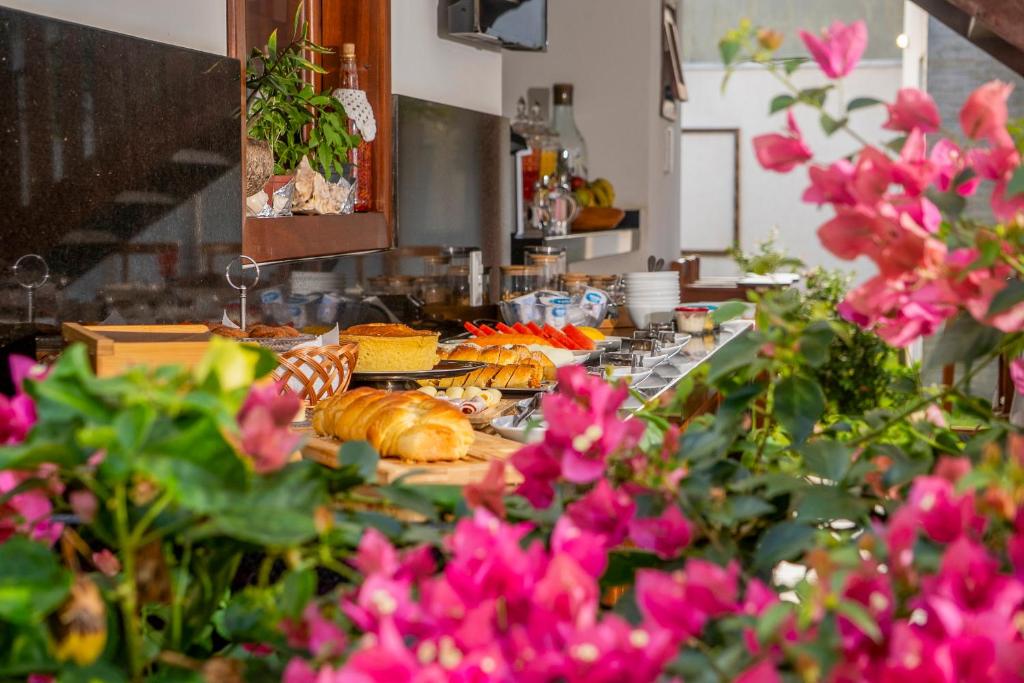 a kitchen with a counter with food and flowers at Aiolos Hotel & Discoveries in Prea