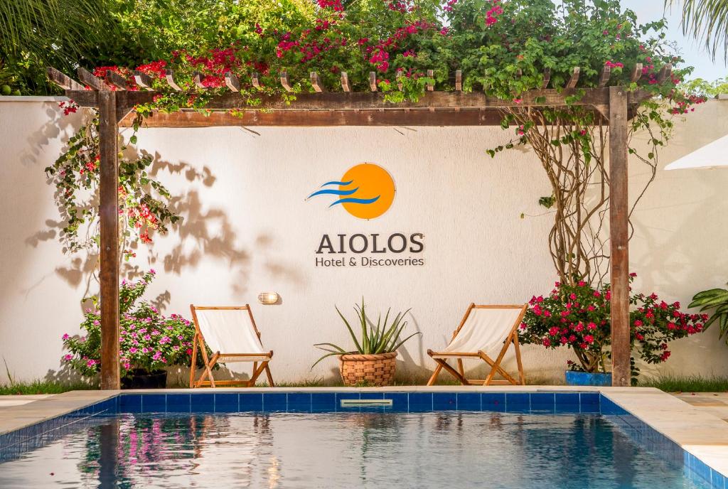 a sign that reads aloha hotels and bedrooms next to a swimming pool at Aiolos Hotel & Discoveries in Prea