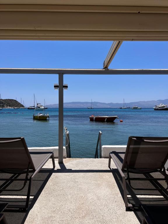 two chairs on a porch with a view of the water at ByAKKAN HOTEL in Bodrum City