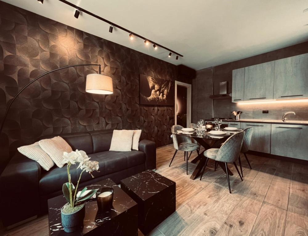 a living room with a leather couch and a table at La Tana Del Ludo in Baveno
