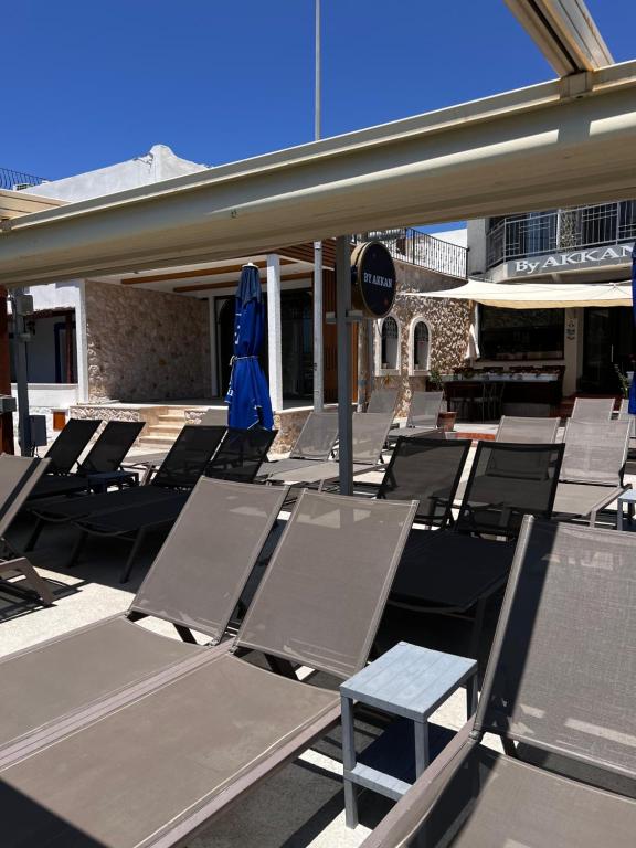 a group of chairs and umbrellas on a patio at ByAKKAN HOTEL in Bodrum City