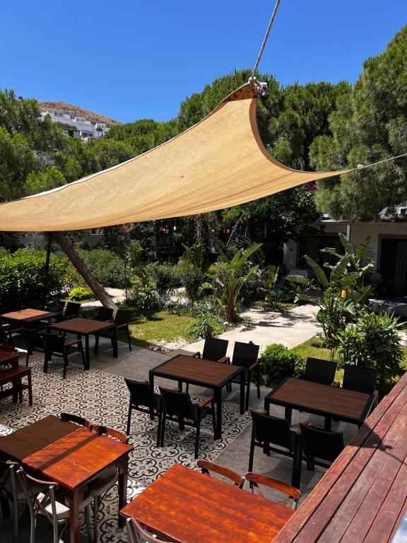 a group of tables and chairs under a canopy at ByAKKAN HOTEL in Bodrum City